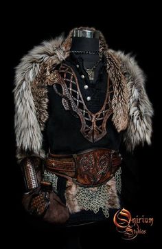 an old fashion outfit with fur and chains on the collar is displayed in front of a black background