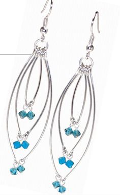 the earrings are made with silver wire and blue glass beads