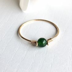 This beautifully simple ring is lovingly handmade with a Jade gemstone and a choice of 14k Gold Filled, 14k Rose Gold Filled or Sterling Silver band. M A T E R I A L S: * Dark Green Jade * 14k Gold Filled, 14k Rose Gold Filled or Sterling Silver S I Z E: * Gemstone - Approximately 4mm * Band Thickness - Approximately 0.8-1mm All of our jewellery is carefully handmade using good quality materials and handpicked gemstones, with the aim to produce quality pieces that you can love & wear for years t Minimalist Handmade Rings For May Birthstone, Minimalist Handmade Rings With May Birthstone, Minimalist Handmade May Birthstone Rings, Green Jewelry With Simple Design As Gift, Simple Green Jewelry For Gifts, Simple Green Jewelry Gift, Green Simple Design Jewelry For Gift, Green Simple Design Jewelry Gift, Elegant Handmade Stackable Rings May Birthstone