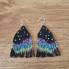 Shimmery Aurora on black background. Ear hooks are stainless steel. Black Fringe Tassel Drop Earrings, Black Fringe Dangle Jewelry, Black Dangle Jewelry With Fringe, Black Tassel Earrings With Ear Wire As A Gift, Black Tassel Earrings With Dangling Beads As Gift, Black Fringe Drop Earrings, Black Fringe Dangle Earrings, Black Beaded Fringe Earrings As Gift, Handmade Black Beaded Long Drop Earrings