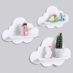 two white clouds with some little figurines sitting on top of one and a cactus in the other