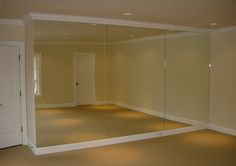 an empty room with no one in it or someone standing on the other side and looking into the mirror