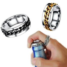 two men's rings with chains on them and a lighter in the other hand