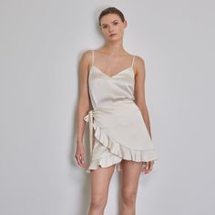 Elegant, softly draped mini wrap skirt made from silk satin. Individually adjustable by tying the waist at the side. Shimmering, glossy look, and Opaque finish thanks to lining. Elevate your ensemble with this statement piece, perfect for any occasion. Material: 100% Silk Lining: 100% Cotton   Made in Italy  Handwash, Cool iron on reverse, Turn garment inside out before cleaning, Do not bleach, Always check the garment care label for specific care instructions Elegant Mini Skirt With Tie Waist, Chic Satin Draped Skirt For Spring, Summer Cocktail Satin Wrap Dress, Elegant Fitted Wrap Skirt, Summer Satin Cocktail Skirt, Chic Satin Draped Cocktail Skirt, Chic Satin Draped Skirt For Cocktail, Summer Satin Skirt For Cocktail Occasions, Satin Cocktail Skirt For Summer