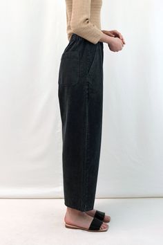 An easy, relaxed, elastic waist trouser with a slight curved leg. Mini dart at front panel, side slash pockets, elasticated waistband and two rounded patch pockets at the back. Made by Micaela Greg in Alameda, CA. CONTENT & CARE:100% Cotton MEASUREMENTS (laying flat):XS - Waist: 12"-16", Front rise: 15", Back rise: 16.5", Hip: 20", Inseam: 23.5"S - Waist: 13"-17", Front rise: 15.5", Back rise: 17", Hip: 20.5", Inseam: 24"M - Waist: 14"-18", Front rise: 16", Back rise: 17.5", Hip: 21", Inseam: 24 Tapered Pants, Grey Pants, Silhouette Design, Winter Looks, S Models, Dart, Trousers Women, Everyday Fashion, Black Pants