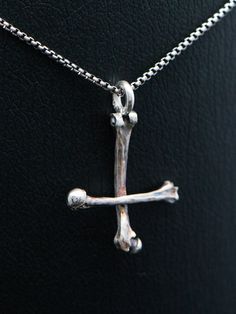 "Silver bone cross necklace, sterling silver round venice chain included. This handmade dark art gothic cross is made from 925 sterling silver with oxidated details. Each piece is made to meet customers desires, so let me know if you want something special included your very own version. Golden version is possible also! Pendants first class finish has a lifetime guarantee and it will be renewed when needed with a cost of postage.  Jewelry will be sent with FedEx International Economy, shipment is included in the price of jewelry. Upgrade to FedEx International Priority for even faster shipment. You can choose between five different finish: 'Polished' has darkened details and polished finish. 'Matte' has darkened details and matte finish. 'Bright white' is polished and details are left brig Gothic Sterling Silver Crucifix Necklace, Gothic Sterling Silver Cross Necklace, Petrine Cross, Black Metal Necklace, Upside Down Cross, Gothic Cross, Gothic Crosses, Saint Peter, Necklace Cross