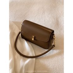 A shoulder bag with a square body and a flap that can hold a smartphone and a small wallet. The golden clasp and small design give it an elegant and stylish impression. It is also possible to remove the shoulder strap. 
 
 
 Color 
 
 Dark brown 
 Black 
 
 
 Size 
 
 
 FREE size 
 
 Height: 14cm 
 Width: 22cm 
 Depth: 6.5cm 
 
 
 
 
 
 Material 
 
 Leather Brown Square Trendy Phone Bag, Brown Baguette Bag With Hasp Closure For Office, Classic Gold Shoulder Bag With Hasp Closure, Trendy Brown Rectangular Phone Bag, Formal Beige Rectangular Baguette Bag, Brown Square Phone Bag For Daily Use, Elegant Gold Satchel With Hasp Closure, Brown Rectangular Shoulder Bag With Hasp Closure, Elegant Solid Color Square Baguette Bag