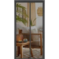 an open sliding glass door in a living room with a table and chair next to it