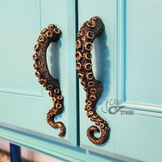 an octopus door handle on a blue cabinet