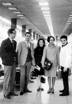 a group of people standing next to each other in front of luggage at an airport