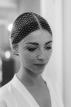 a woman wearing a veil and looking at her cell phone