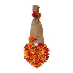 a burlock with fall leaves on it hanging from the side, and a small bag in the shape of a scarecrow