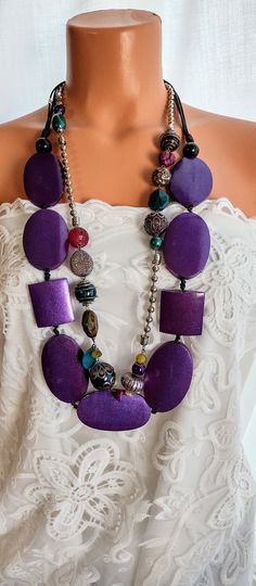 Boho necklace set of two Estate Jewelry This unique eye catcher t is perfect for Wedding, Vacation, Day or evening wear. Materials: Purple lightweight wood Glass beads, Silver beads, Stone beads Chunky silver chains 4 Strand Leather cords knotted. Measurements: Purple necklace 36 inches                              Bead necklace 34 inches Closure by loop & button Ready for shipping MO waiting  Thanks for visiting kaysclassyboutique@etsy.com. Bohemian Beaded Layered Necklace For Party, Bohemian Multi-strand Jewelry For Parties, Purple Large Beaded Necklace, Colorful Beads Long Necklace Gift, Beaded Long Layered Necklace For Gifts, Colorful Beads Long Necklace As Gift, Bohemian Double Strand Layered Necklace For Party, Handmade Long Layered Necklace As Gift, Colorful Beads Double Strand Long Necklace As Gift