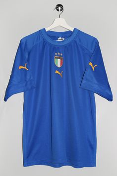 "Puma Italy T-shirt - Size tag: Please always check measurements before buying. Men's XL - Measurements (laying flat): Pit to Pit: 22\" Length: 28.5\" Pit to cuff: 7\" -Wear: /Please see images for details/ Good used condition. Couple of small fabric pulls front and back as shown on the pictures. - Fabric: Polyester *All of our items are preloved pieces so some signs of natural wear and age are to be expected. Please look through the photos carefully to check if the condition is to your satisfaction. *All efforts are made to show any defects however small imperfections may be missed. *We try to describe the sizes as accurately as possible, but please keep in mind that sizes nowadays can differ to sizes used back then. Please note the measurements in the description for the exact size. -Del Blue Short Sleeve Jersey With Team Name, Blue Jersey T-shirt Sportswear, Blue Jersey T-shirt For Sportswear, Fan Merchandise Short Sleeve Jersey, Blue Short Sleeve Jersey For Sports Events, Blue Moisture-wicking Sportswear T-shirt, Blue Sportswear T-shirt For Sports Season, Blue Crew Neck T-shirt For Sports Season, Blue Short Sleeve Sports Jersey