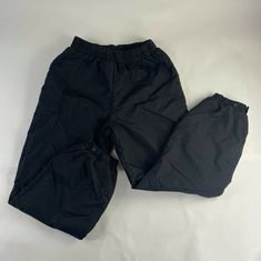 Nylon Gym Pants, Sporty Solid Color Nylon Pants, Sporty Nylon Pants In Solid Color, Solid Nylon Sportswear Pants, Sporty Solid Nylon Cargo Pants, Sports Parachute Pants With Pockets, Nylon Sports Joggers With Pockets, Black Moisture-wicking Cargo Pants For Outdoor Activities, Black Moisture-wicking Cargo Pants For Outdoor