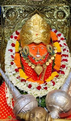 an idol is displayed with flowers and decorations