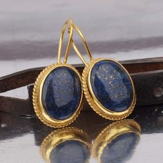 These exquisite Ancient Roman Art Handcrafted Large Lapis Earrings are meticulously made by the skilled artisans at Makeitbylove Workshop in Bodrum, Turkey. Crafted with attention to detail, these earrings showcase the beauty of ancient Roman art. The earrings measure 40 mm  in length, 18  X 13 mm in width, and have a weight of 9.59 grams. They are adorned with sparkling amethyst gemstones, adding a touch of elegance About Us: At Makeitbylove, we are passionate jewelry designers based in Bodrum, Turkey. Our workshop specializes in creating handcrafted Turkish jewelry that captures the beauty and craftsmanship of ancient art. We are dedicated to delivering exceptional quality pieces that showcase the rich cultural heritage of our region. Customization Options: We offer customization options Artisan Oval Earrings As A Gift, Handmade Oval Fine Jewelry Earrings, Handmade Oval Earrings In Fine Jewelry Style, Handmade Lapis Lazuli Jewelry For Formal Occasions, Artisan Oval Earrings For Gifts, Artisan Round Earrings For Formal Occasions, Oval Brass Earrings As Gift, Handmade Lapis Lazuli Jewelry For Anniversary, Artisan Gold Jewelry With Lapis Lazuli