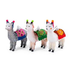 three llamas with ornaments on their backs