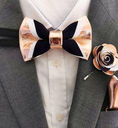 "These are genuine soft leather bow ties and lapel flower combination. Colors on photos: ROSE GOLD, IVORY AND NAVY. All can adjusted to your wishes and needs. The secondary color that you can choose from is for the top navy part.  We also offer matching pocket square cards and lapel flower pins/boutonnieres that you can find in our shop. This unique and eye-catching leather bow tie is handcrafted in Slovenia in Europe with high quality soft italian leather. It suits a variety of styles, from a casual look with a simple shirt to formal wear. Item Details: BOUTONNIERE; 2\"  MENS BOW TIE: * Pre-tied bow size: 4\" x 2.5\" approx. * Adjustable fabric strap with metal hardware to neck size: 14\" - 19.5\" BOYS BOW TIE: * Pre-tied bow size: 3.5\" x 2\" approx. * Adjustable fabric strap with metal Party Suit And Tie Accessories For Father's Day, Elegant Bow Tie For Father's Day Party, Luxury Bow Tie As Gift, Gold Bow Suit And Tie Accessories As Gift, Classic Bow Tie For Father's Day Party, Gold Suit And Tie Accessories With Bow For Gift, Elegant Black Bow Tie For Father's Day, Copper Ideas, Bow Tie For Men