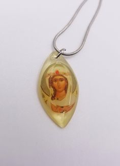 Subtle and beautiful, these miniature pendant necklaces feature traditional Orthodox Christian icons.  Each miniature icon is set in a hand-poured resin pendant and hangs on an 18-inch, 925 silver-plated snake chain with a lobster clasp.  The pendants are slightly longer than one inch. More options available in our shop! www.pocketprayercloset.com  Each piece of jewelry from Pocket Prayer Closet is individually handmade.  Artwork for these pieces sourced from 6dogarts. Engraved Pendant Necklace Souvenir, Spiritual Pendant Necklaces As Souvenirs, Spiritual Pendant Necklace For Souvenir, Personalized Silver Necklace For Souvenir, Amber Oval Pendant Necklace, Spiritual Clear Pendant Jewelry, Spiritual Silver Jewelry Souvenir, Symbolic Oval Pendant Jewelry For Gifts, Spiritual Souvenir Pendant Jewelry