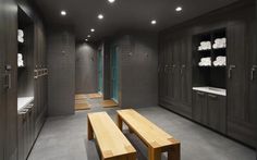 a large bathroom with two wooden benches in it