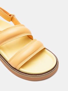 The favorite sandals of street-style? The ROAD PEACH, designed with Nappa leather straps to be the must-have of the season. Their molded insole, elevated rubber sole in pastel yellow, and slingback silhouette make them perfect for strolling through your favorite city, going to work, or a date with your friends. The contrasting embossed logo adds an elegant touch. Pair them with your favorite dress or denim for a casual-chic look. Style: Slingback sandals with two straps. Sole Height: 4.5 cm. Yellow Round Toe Slingback Sandals Casual, Yellow Round Toe Slingback Sandals, Casual Yellow Slingback Sandals With Round Toe, Yellow Casual Slingback Sandals, Yellow Slingback Sandals With Removable Insole, Casual Yellow Leather Sandals, Summer Double Strap Slingback Sandals With Branded Insole, Trendy Yellow Leather Sandals, Spring Slingback Sandals With Leather Footbed