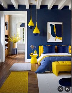 a bedroom with blue walls and yellow accents