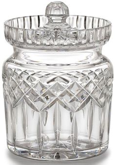 a clear glass jar with a lid on it's side and an ornate design