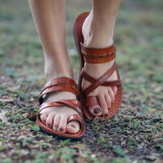 Let Rachel toe loop sandals alter your outlook with their handcrafted, soft vegetable tanned leather and unique design, perfect for any occasion. Featuring cross-stitched details, crisscross straps, and a soft toe loop, these sandals provide a comfortably secure fit while growing more comfortable with time. Effortlessly complement sweet summer dresses, casual Friday jeans, or adventurous explorations with these unique toe ring sandals that adapt to your unique footprint. 100% vegetable-tanned na Toe Ring Sandals, Toe Loop Sandals, Criss Cross Sandals, Handmade Sandals, Toe Ring, Sweet Summer, Casual Friday, Toe Rings, Vegetable Tanned Leather