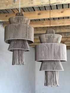 two woven lamps hanging from the ceiling