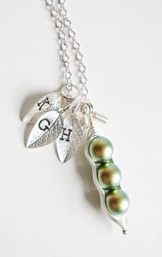 I wrap iridescent green color crystal pearls in wire to make them look like these really cute little pea pods! You can choose your desired pea count and add hand-stamped leaf charms with initials. Perfect gift for mothers and grandmothers (to be), as well as baby shower gifts! Some like to request these as matching best friends or bridesmaids necklaces as well. Each crystal pearl measures at 8mm. One pod can fit up to 5 crystal pearls. If you need it to represent more than that, you can request Whimsical Green Jewelry For Gifts, Whimsical Green Nickel-free Jewelry, Green Nickel-free Jewelry For Mother's Day, Cute Green Jewelry Gift, Green Pearl Jewelry For Gifts, Bridesmaids Necklaces, Necklace Best Friends, Sisters Necklace, Jewelry For Mom