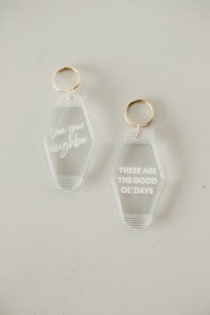 two clear acrylic keychains that say, one is for each other there are the good old days