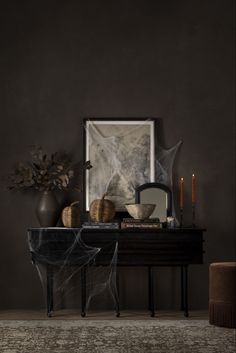 a black table with two chairs and a painting on the wall