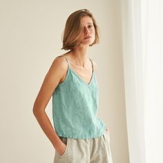 "You can never have too many all-season friendly tops. FEATURES: * relaxed fit * spaghetti straps * wrinkly fabric * top length is 50 cm / ~20\" (size S) * 100 % natural, certified linen fabric * dyed and washed in small batches * natural cotton yarns * handmade at a small studio in Europe COLORS: Dyed and washed in small batches, so the color will be unique and superb quality to each piece. Please check the color options on the side menu. SIZE GUIDE / BODY MEASUREMENTS: XS Bust 28- 31\" (72- 80 Spring V-neck Camisole With Adjustable Straps, Relaxed Fit V-neck Tank Top For Spring, Summer V-neck Camisole For Vacation, Cotton V-neck Camisole With Adjustable Straps, Summer Cotton V-neck Camisole, Relaxed Spring Tank Tops, Green V-neck Summer Camisole, Green Relaxed Fit Tank Top For Summer, Relaxed Fit Green Tank Top For Summer