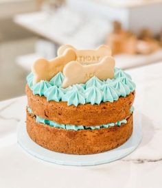 a cake with frosting and a dog bone on top is sitting on a counter