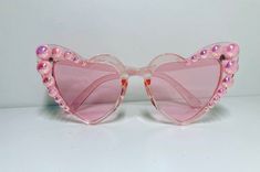 Our signature heart sunglasses in pink translucent with pink ab pearls Trendy Pink Sunglasses For Valentine's Day, Feminine Pink Tinted Sunglasses, Pink Heart-shaped Sunglasses With Mirrored Lenses, Pink Tinted Sunglasses For Party, Pink Heart-shaped Party Sunglasses, Heart Sunglasses, Summer Sunglasses, Eyewear Sunglasses, Sunglasses Accessories