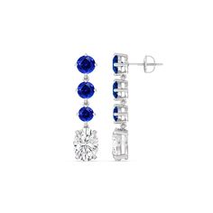 These diamond danglers exude a sense of sophistication and ease. They look relaxed and refined at once with their linear design and subtle movement. Each earring features a trio of round created sapphire set in a vertical row and punctuated by a larger oval-cut diamond at the end. This elegant pair is the perfect choice when you want to dress to impress yet still be comfortable. Modern Round Linear Earrings For Formal Occasions, Modern Linear Round Earrings For Formal Occasions, Elegant Diamond White Three Stone Diamond Earrings, Elegant Three Stone White Gold Earrings, Formal Diamond Three Stone Earrings, Modern Sapphire Earrings For Formal Occasions, Formal Three Stone Diamond Earrings, Elegant Round Lab-created Sapphire Earrings, Diamond Danglers