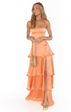 Get swept away by romance in the Lady Corset Dress. Beautiful tiers of luxe satin fall to a maxi hem with a side slit, and topped with a figure flattering corset bodice! Let her be the statement of your look paired with dainty jewelry and barely there heels. Pastel Dress Formal, Orange Prom Dresses, Orange Bridesmaid, Prom Dress Inspo, School Dance Dresses, Spring Capsule, Pastel Dress, Prom Dress Inspiration, Cute Prom Dresses