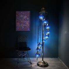 a chair sitting next to a lamp in a room with blue lights on the walls