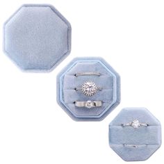 three rings are sitting in a blue velvet ring box with two diamonds on each one