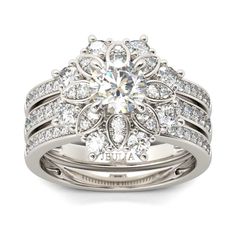 a diamond engagement ring set with matching wedding bands and an intricate flower design on the band