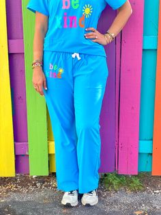 Our adorable Be Kind Scrubs were made for all of our favorite healthcare providers! Be bright, happy + kind! Make people smile everywhere you go! These scrubs do have some stretch to them! The bottoms have a pocket on each side under the waistband, and one in the back! Our scrubs fit true to size! Our scrubs tops and bottoms are sold separately. Fun Stretch Bottoms With Elastic Waistband, Playful Blue Pants With Pockets, Playful Relaxed Fit Bottoms With Pockets, Stretch Cotton Fun Bottoms, Fun Blue Cotton Bottoms, Playful Stretch Blue Bottoms, Navy Blue Scrubs, Scrubs Outfit, Trendy Tees