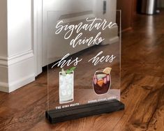 there is a glass sign that says congratulations drink and has two shots in it on the floor