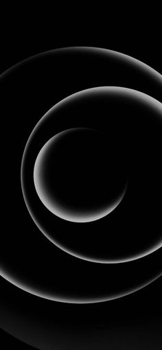 an abstract black and white photo with circles in the center, on a dark background