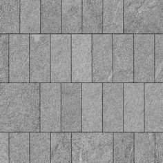 a close up view of a gray brick wall textured with small squares and rectangles