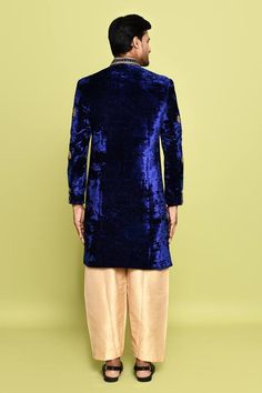 Royal blue sherwani featuring salli and sequin embroidery on the collar and sleeves. Paired wit a solid gold pant. - Aza Fashions Fitted Royal Blue Kurta For Festive Occasions, Festive Royal Blue Fitted Kurta, Velvet Traditional Ceremonial Wear For Eid, Ceremonial Velvet Traditional Wear For Eid, Traditional Velvet Bandhgala For Wedding, Velvet Bandhgala For Eid Festivities, Fitted Velvet Kurta For Wedding, Festive Velvet Long Sleeve Sherwani, Blue Sherwani With Mirror Work In Traditional Drape