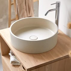 a white sink sitting on top of a wooden counter