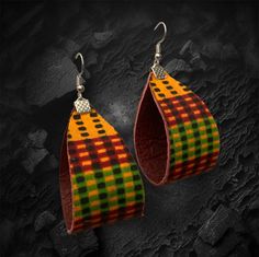 "These versatile, unique and colorful dangle earrings are crafted with genuine deep red leather with traditional Kente pattern in orange, black, red and green. Substantial but not too heavy, they hang 3\" with silver-toned findings and fish hook ear wire." Red Teardrop Earrings For Festival, Red Leather Earrings For Gifts, Traditional Brown Earrings For Festival, Adjustable Red Leather Earrings, Handmade Brown Earrings, Multicolor Hand Tooled Jewelry For Gifts, Multicolor Hand Tooled Jewelry As Gift, Multicolor Hand Tooled Jewelry Gift, Red Leather Earrings