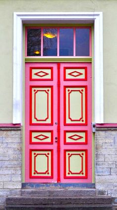 a red door with two windows and steps