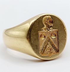 French Antique signet ring 18k gold coat of arms decorated with an helmet, an eagle and two horseshoe (circa 1920) seal, knight Magnificent and rare French seal signet ring Size: 56 FR / 7.5 US Weight: 17.55 g Head size: 14.5 x 13 mm Micro scratches from use and small dents Owl hallmark and goldsmith hallmark (French hallmark) Visit my shop for even more antique jewelry: https://www.etsy.com/shop/AugustusJewels Luxury Vintage Signet Ring With Coat Of Arms, Formal Yellow Gold Coat Of Arms Ring, Classic Collectible Signet Ring With Coat Of Arms, Luxury Yellow Gold Signet Ring With Coat Of Arms, Formal Gold Signet Ring With Coat Of Arms, Luxury Yellow Gold Coat Of Arms Signet Ring, Formal Yellow Gold Signet Ring With Coat Of Arms, Formal Yellow Gold Engraved Ring With Coat Of Arms, Heirloom Oval Signet Ring With Coat Of Arms